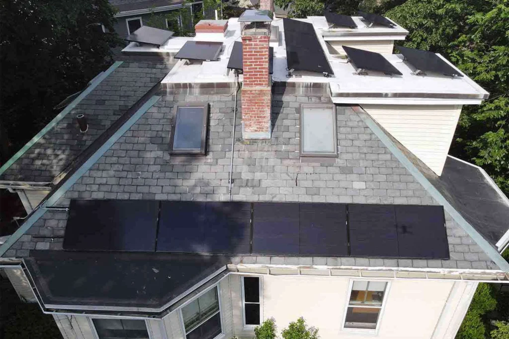 Solar panels mounted on a slate roof with the SlatePlate system, showing the finished installation