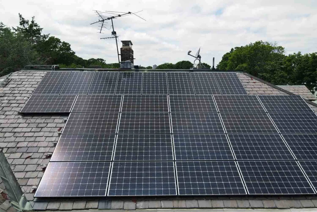 Solar panels mounted on a slate roof with the SlatePlate system, showing the finished installation