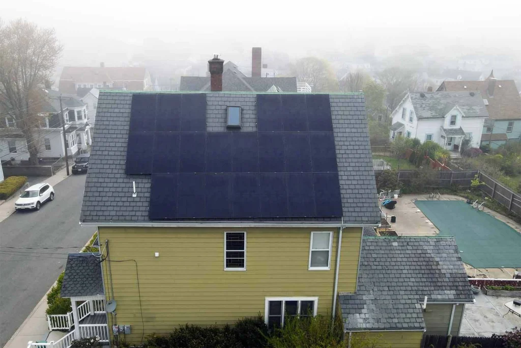 Solar panels mounted on a slate roof with the SlatePlate system, showing the finished installation