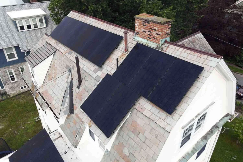 Solar panels mounted on a slate roof with the SlatePlate system, showing the finished installation